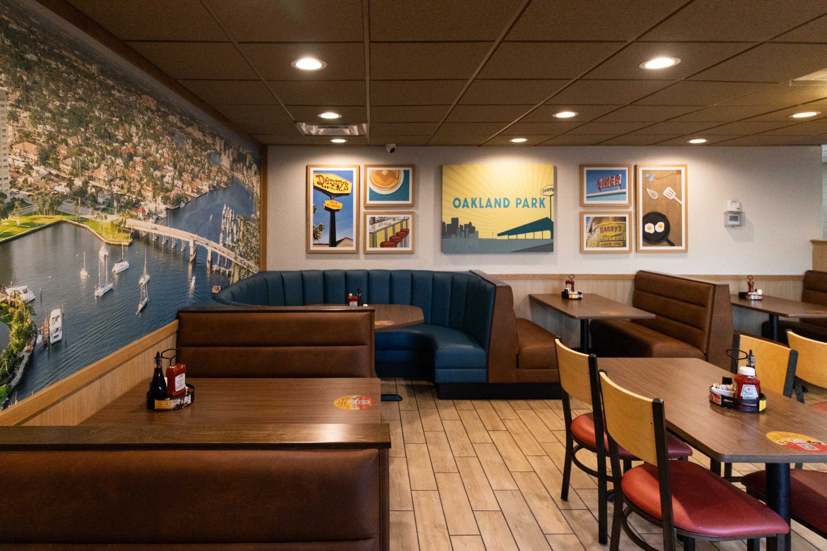 Denny's booth seating with Oakland mural